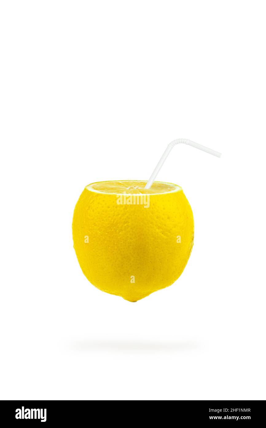 Summer refreshing drink. Levitation of lemon slices with a straw on white background. Levitation of freshly cut lemon, vertical, closeup. Stock Photo