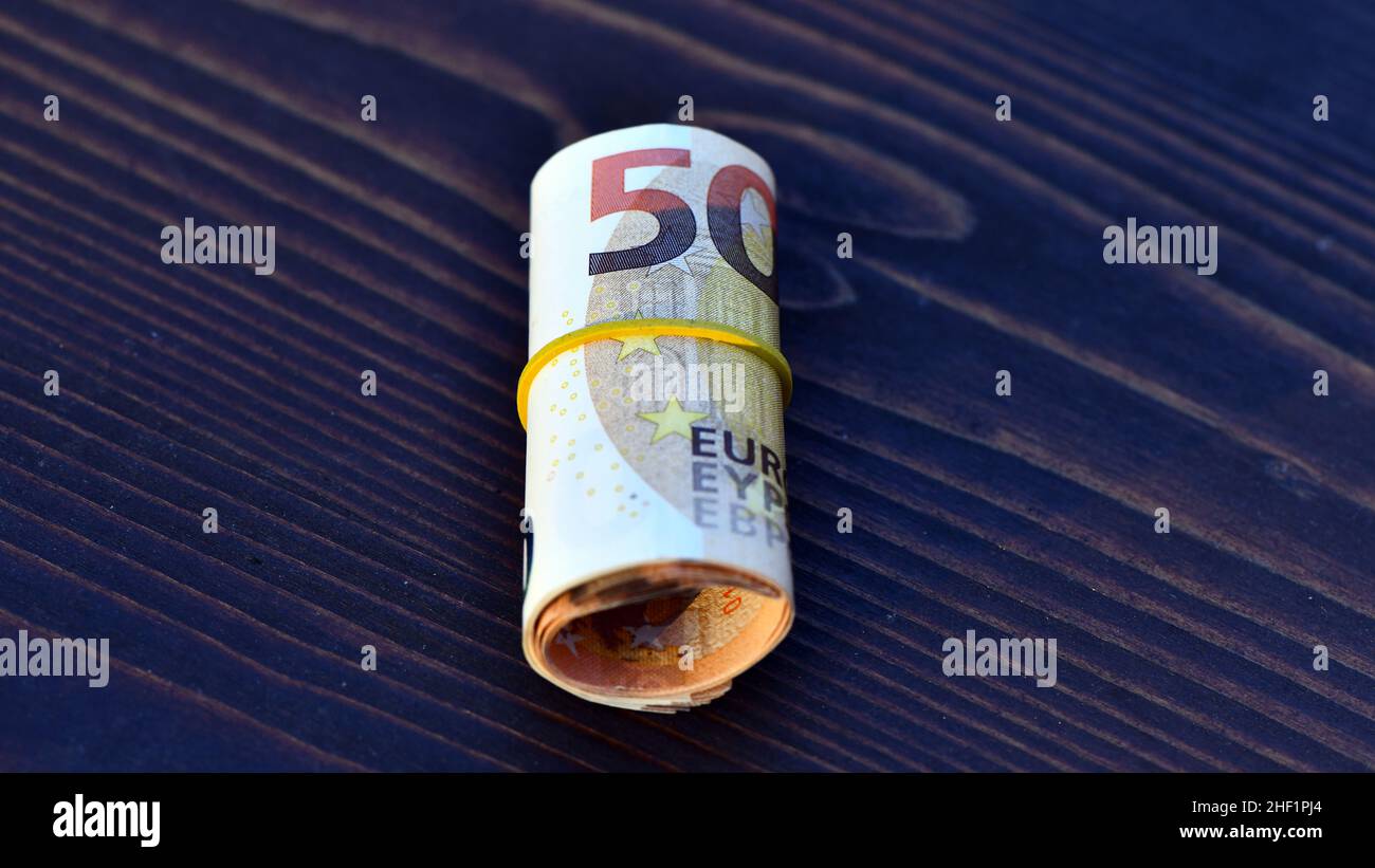 Roll of 1000 Euro in 50 Euro banknotes. Stack of money of Europe. Bunch of euro money. Stack of 50 euro Stock Photo
