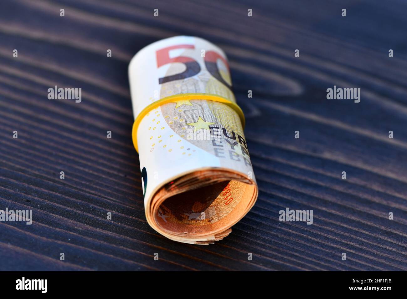 Roll of 1000 Euro in 50 Euro banknotes. Stack of money of Europe. Bunch of euro money. Stack of 50 euro Stock Photo