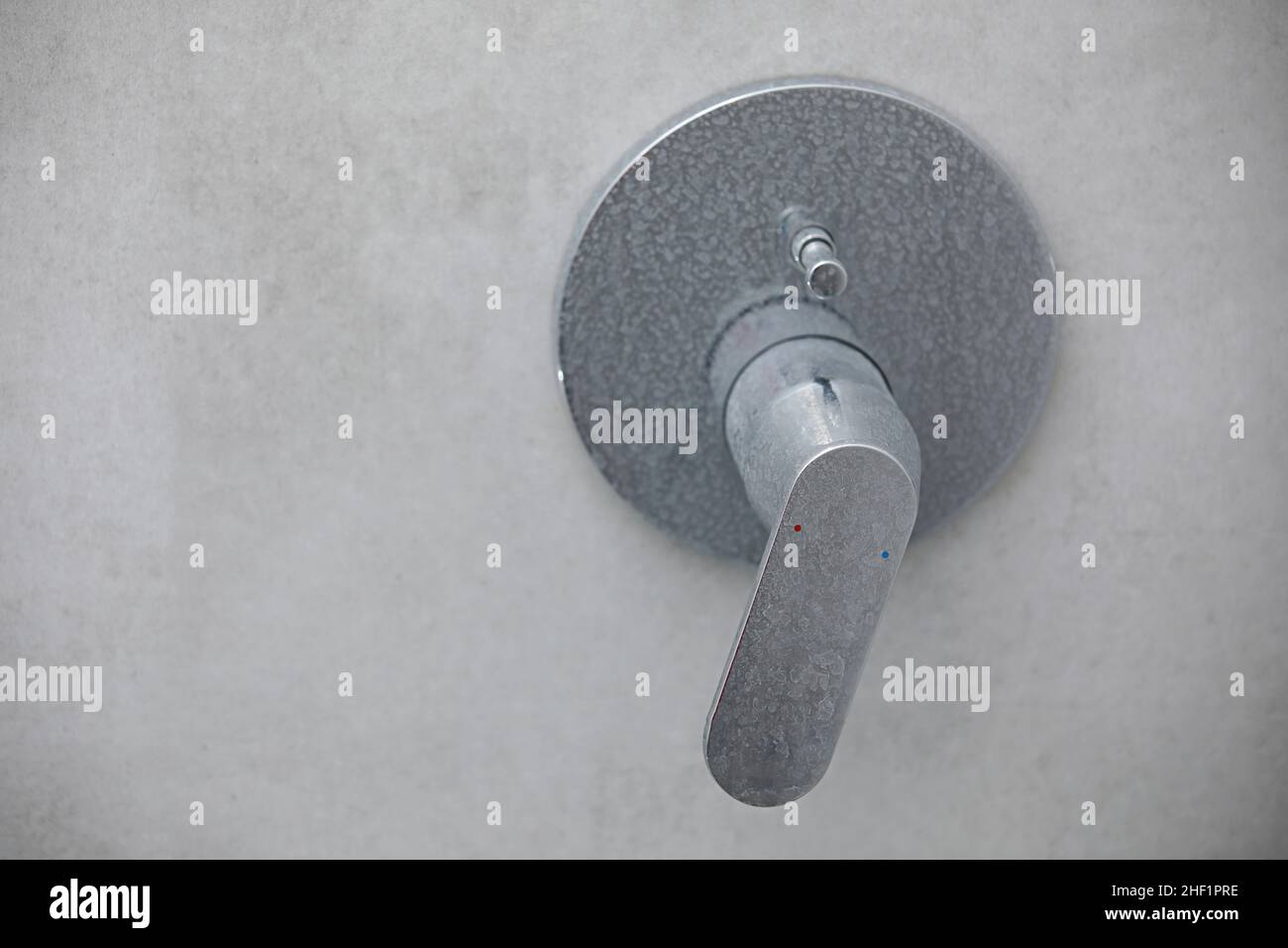 Dirty calcified shower mixer tap, faucet with limescale on it, plaque