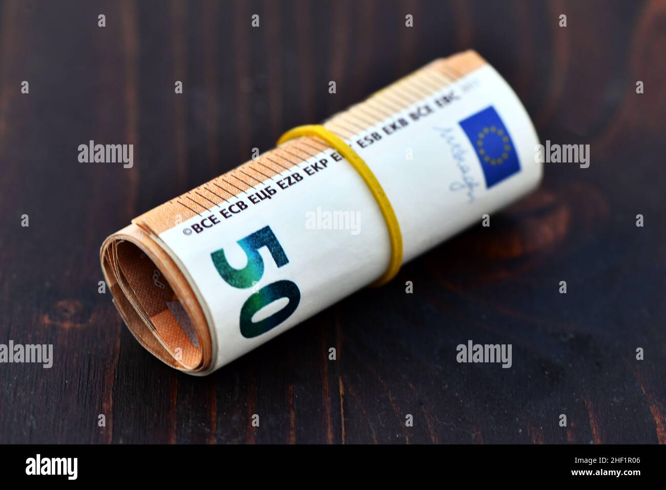 Roll of 1000 Euro in 50 Euro banknotes. Stack of money of Europe. Bunch of euro money. Stack of 50 euro Stock Photo