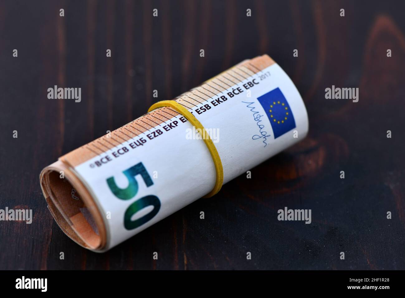 Roll of 1000 Euro in 50 Euro banknotes. Stack of money of Europe. Bunch of euro money. Stack of 50 euro Stock Photo