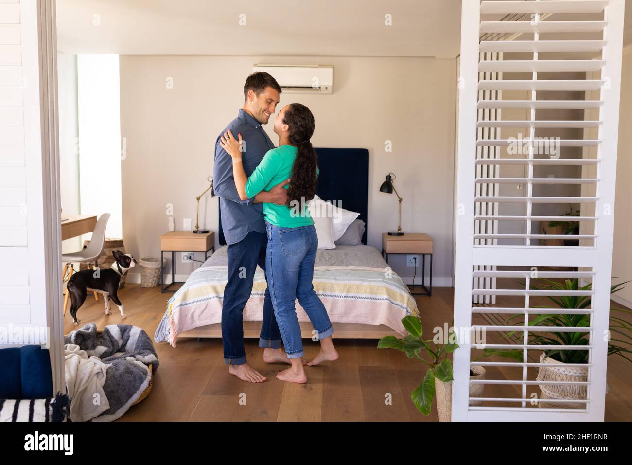 Caucasian couple dancing together in the living room at home Stock Photo