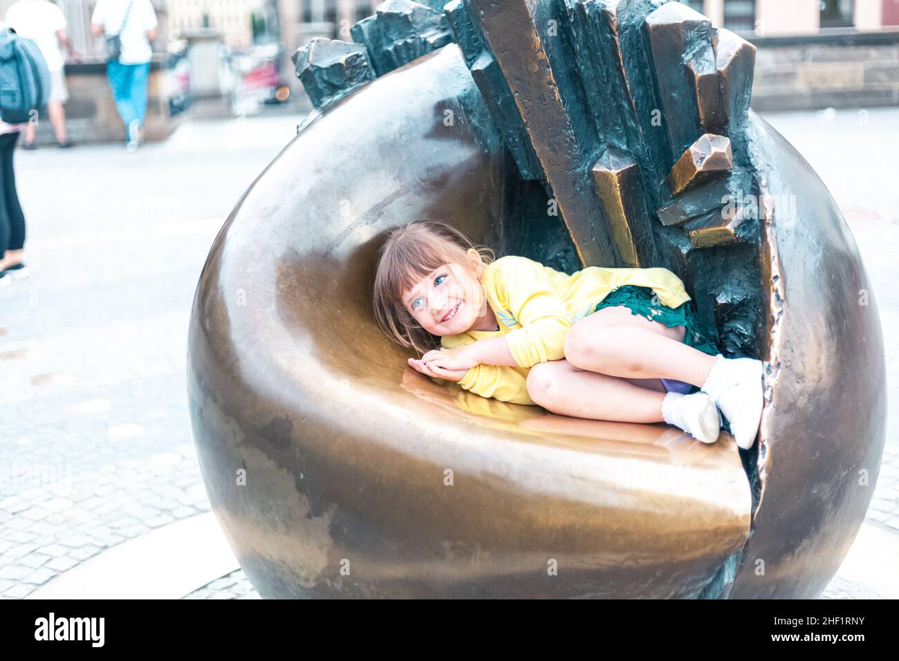 child sitting on a sculpture Stock Photo