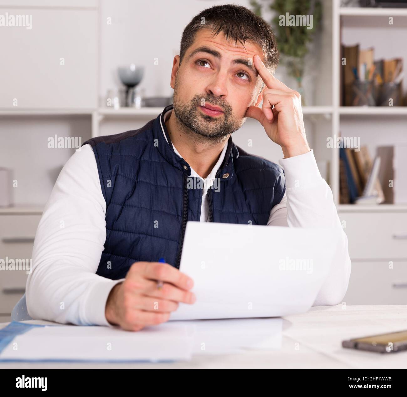 Distressed male having problems with paying utility bills Stock Photo