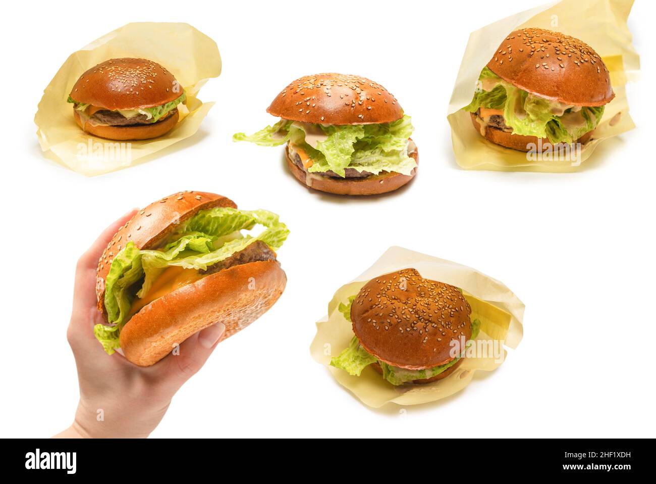 Hamburger in woman hands isolated on a white background. Top view. Stock Photo
