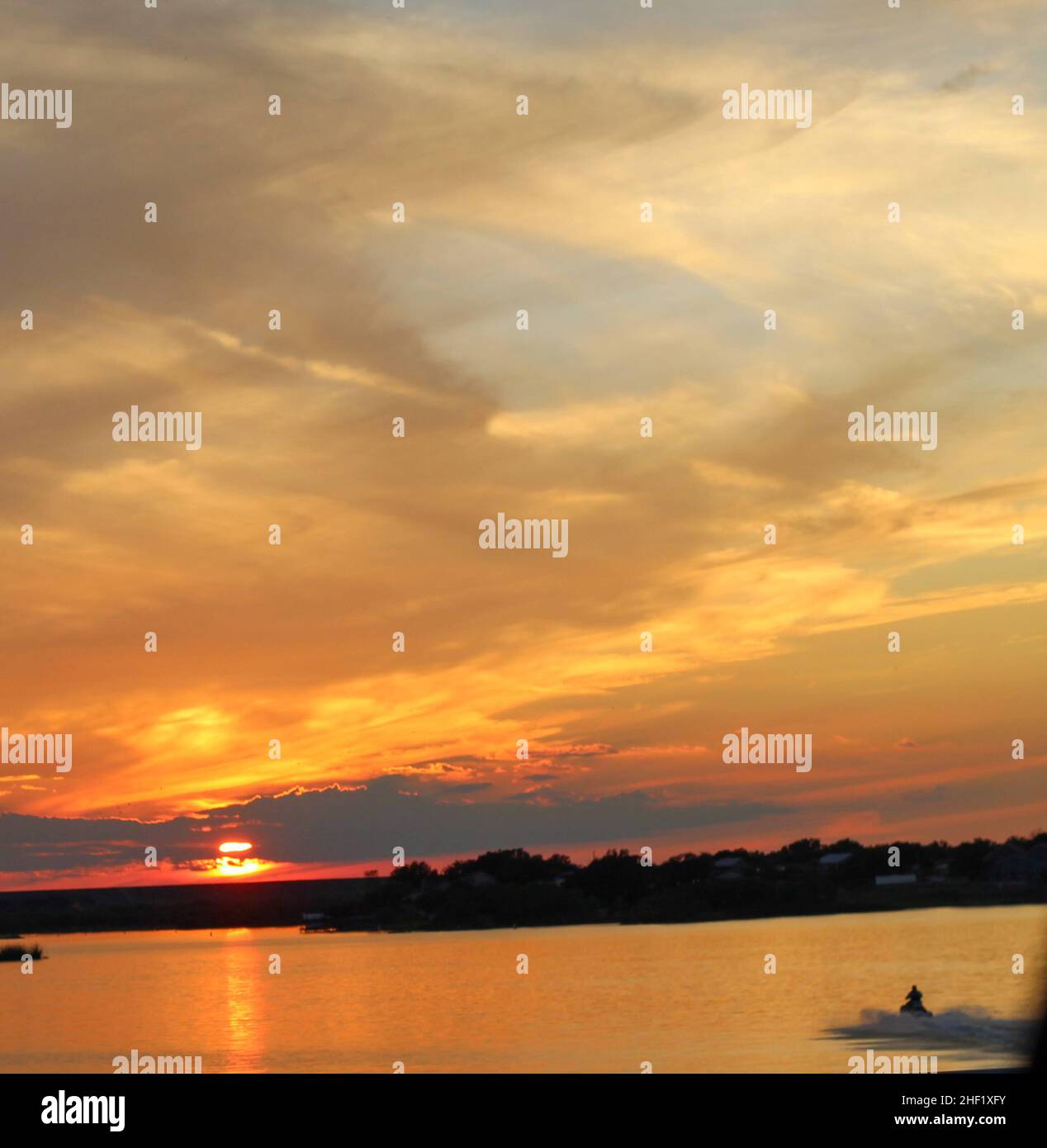 A jet ski riding towards the setting on Lake Nasworthy in San Angelo, Texas, USA Stock Photo Alamy