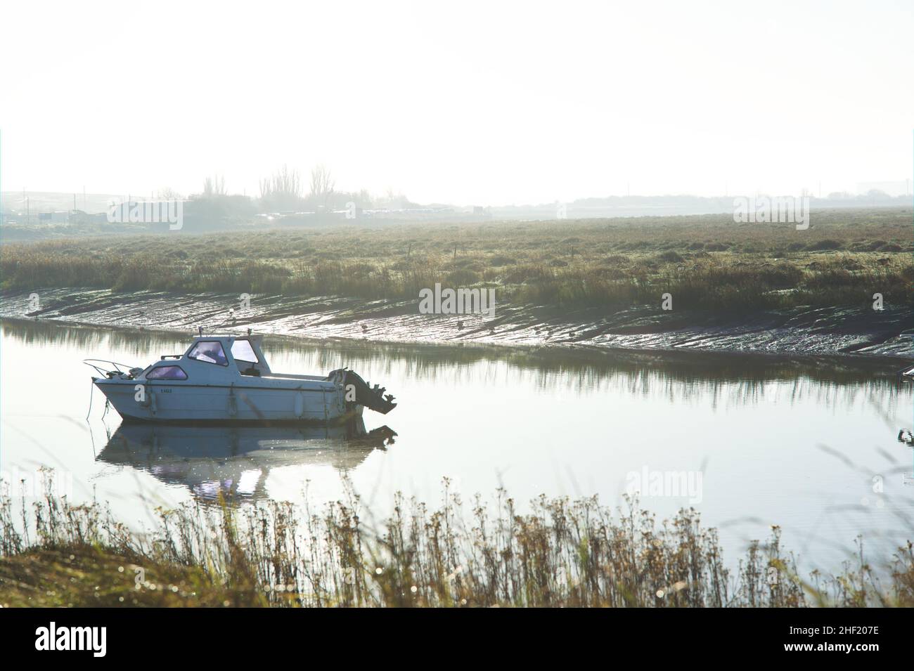 Britain, Essex Landscapes - A motorboat moored at Pitsea Creek on a misty winter morning. Stock Photo