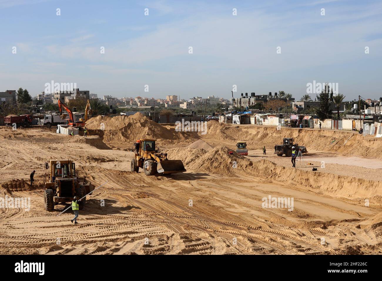 Teams run Egyptian machinery at the construction site of a new housing complex, which to be named 'The City of Egypt' in Gaza Strip, on Jan 12, 2022. Stock Photo