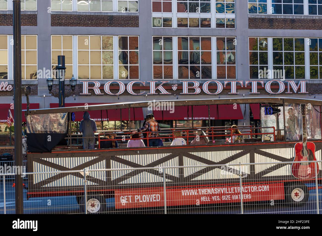 Nashville, Tennessee, USA - November 7, 2021: Touring bar drives past the Rock Bottom Cafe in old town Nashville Stock Photo