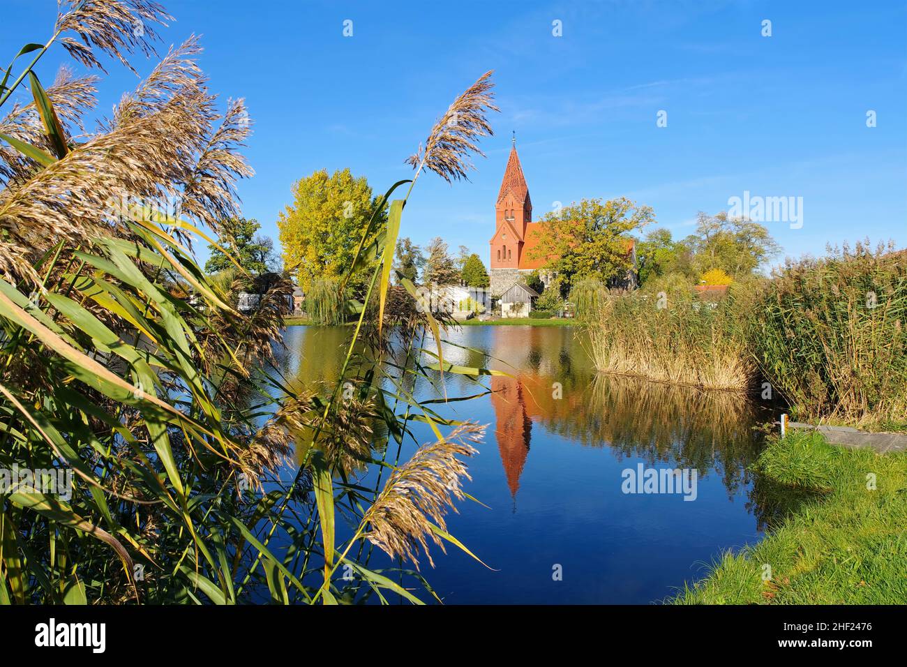 the village Muerow in the Uckermark, old church with pond Stock Photo