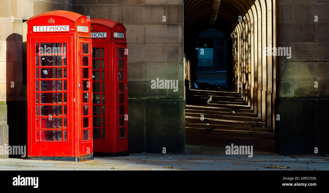 two red telephone boxes in the city UK Stock Photo