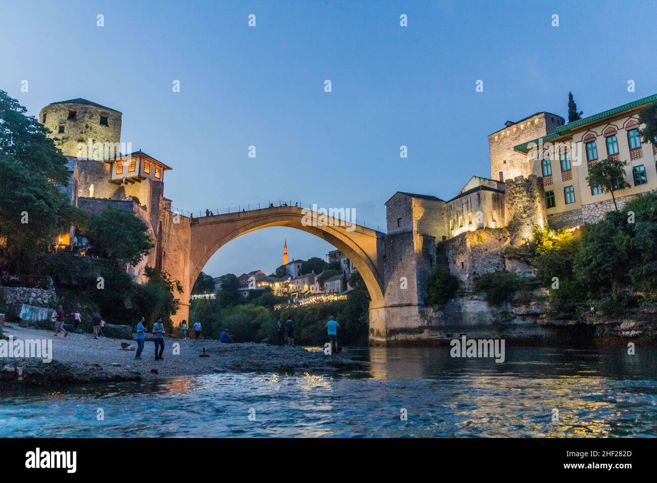 MOSTAR, BOSNIA AND HERZEGOVINA - JUNE 10, 2019: Evening view of Stari most (Old Bridge) and old stone buildings in Mostar. Bosnia and Herzegovina Stock Photo