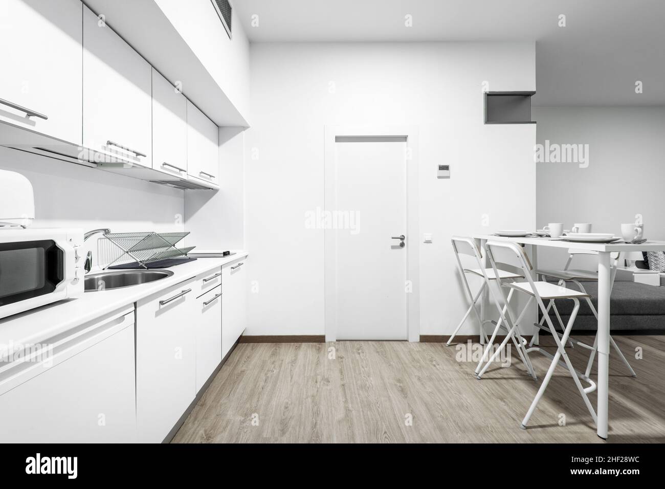 Kitchen and living-dining area in a vacation rental studio with breakfast-on-the-table service Stock Photo