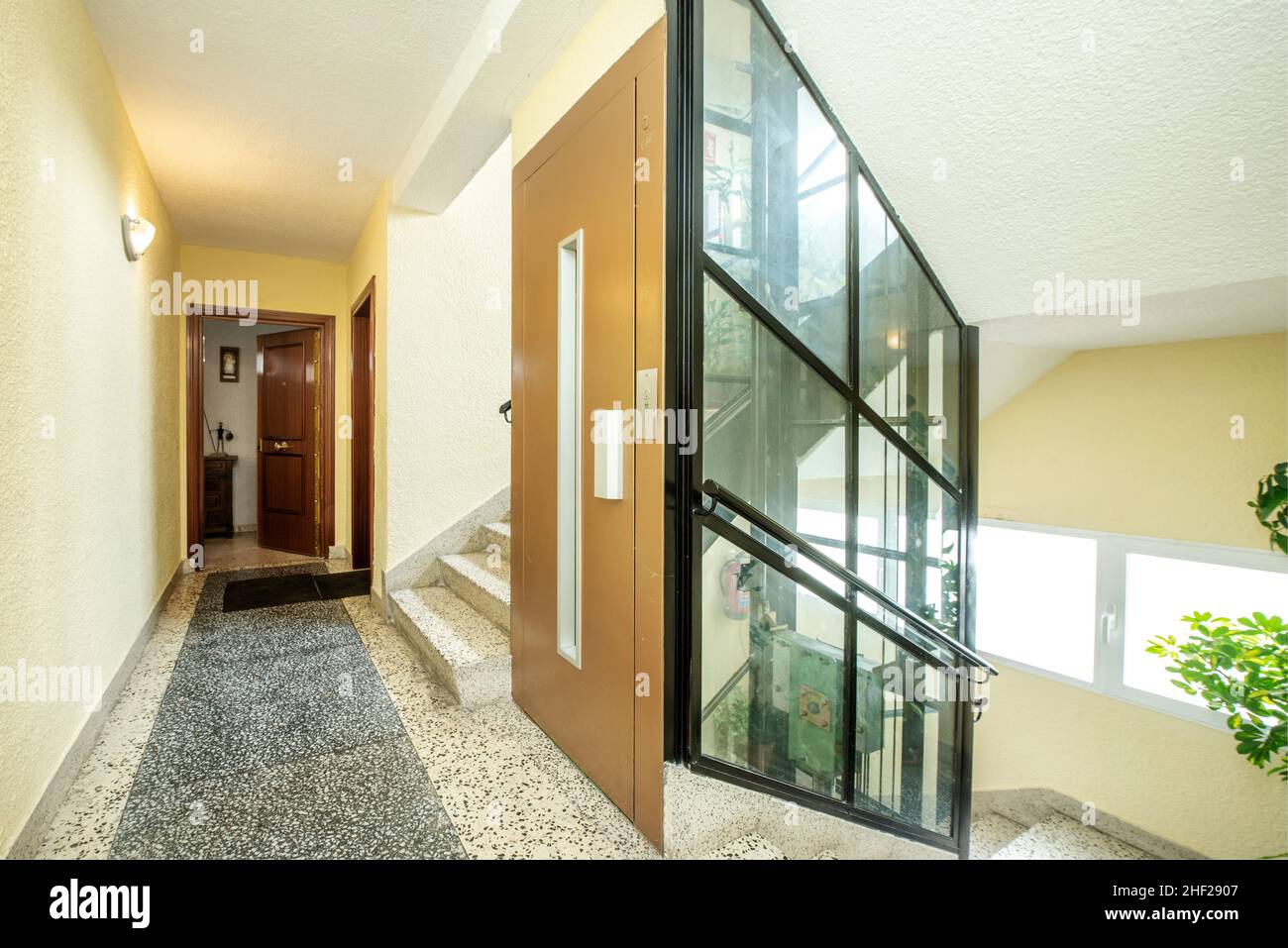 Common areas of a residential building with an elevator shaft covered with glass panels Stock Photo