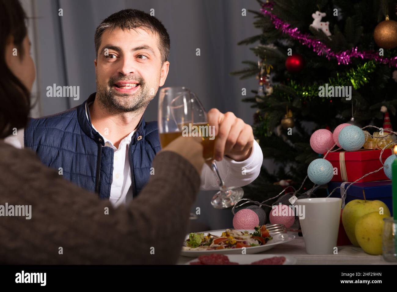 Couple having christmas dinner and watching tv Stock Photo