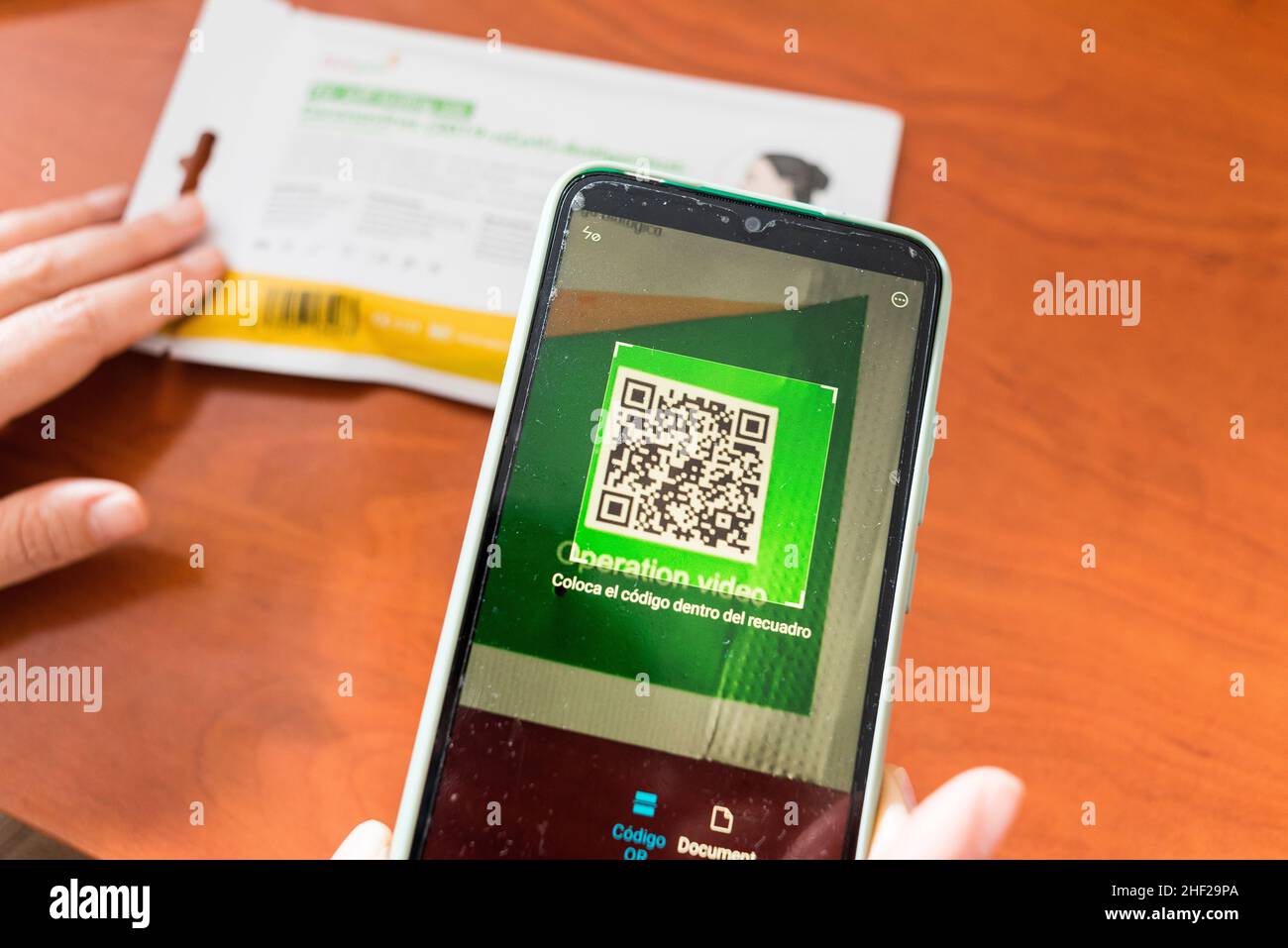 Seville. Spain. 28 December, 2021. Close-up of a smartphone scanning the QR code of a Covid19 antigen self-test kit to obtain information on the proce Stock Photo