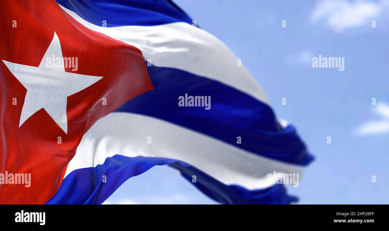 Detailed close up of the national flag of Cuba waving in the wind on a clear day. Democracy and politics. Latin american country. Selective focus. Stock Photo