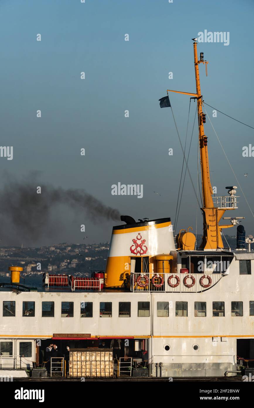 Istanbul, Turkey January 5th 2022 A Turkish Bosporus passenger ferry pumping out think black smoke from its funnel as it arrives at the European side Stock Photo
