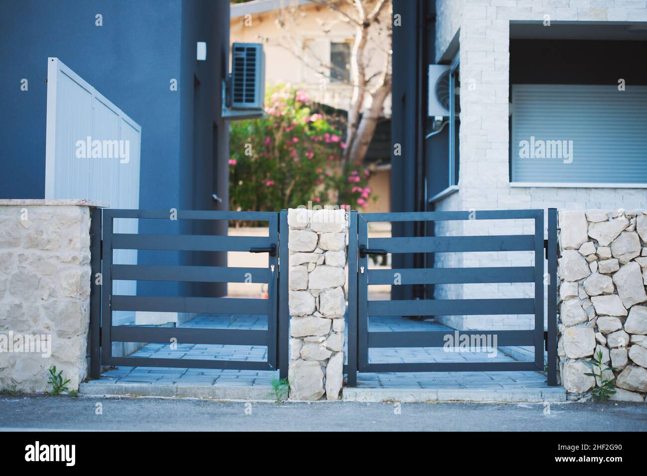 The courtyard door and the passage between the two buildings. Mediterranean style of construction. Stock Photo