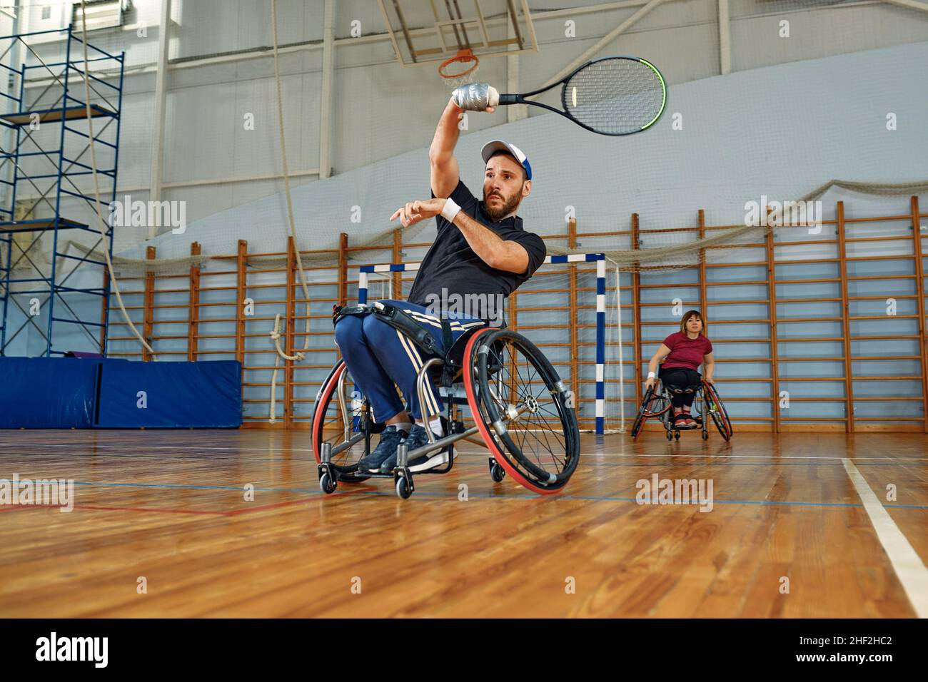 People in wheelchair playing tennis on court. Wheel Chair Tennis For