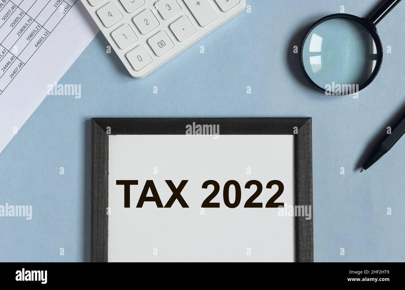 Tax 2022, taxation system. Word on blue office desk. Stock Photo