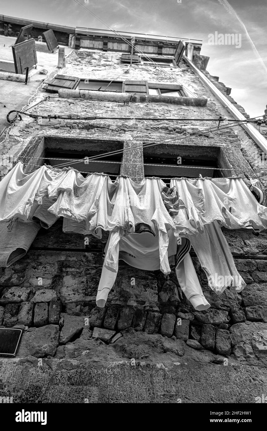 Clothesline hanging in the street of the old town of a European city Stock Photo