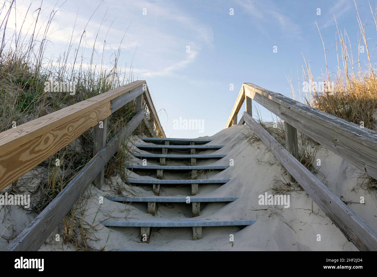 A boardwalk built over huge sand dunes provides access to the quiet southern beaches on Jekyll Island, Georgia, a popular slow travel destination. Stock Photo