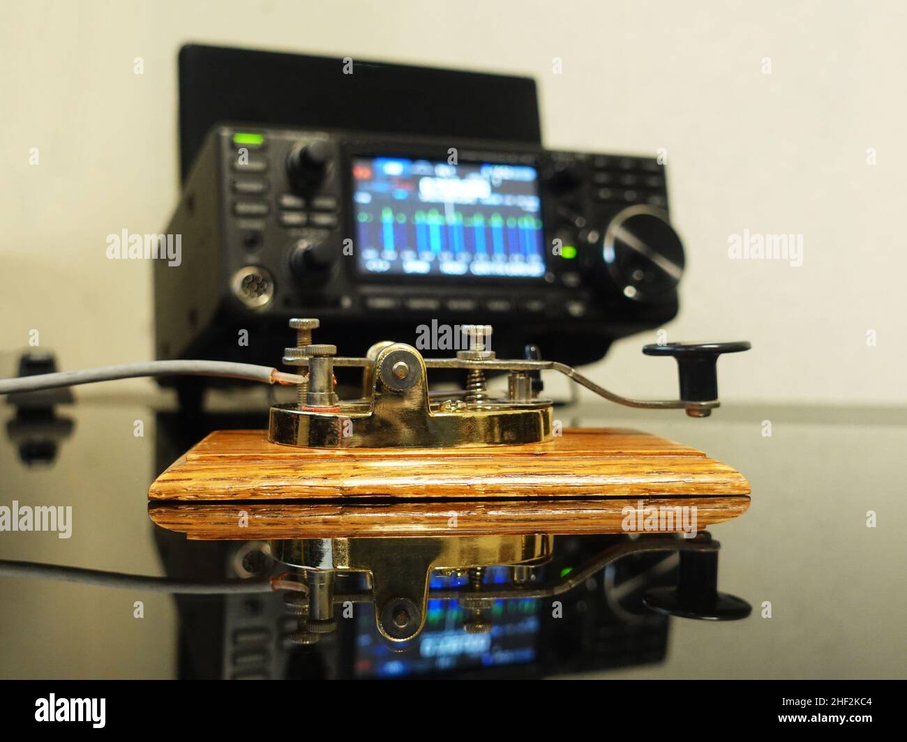 Selective focus on a telegraph key with radio defocused in background Stock Photo