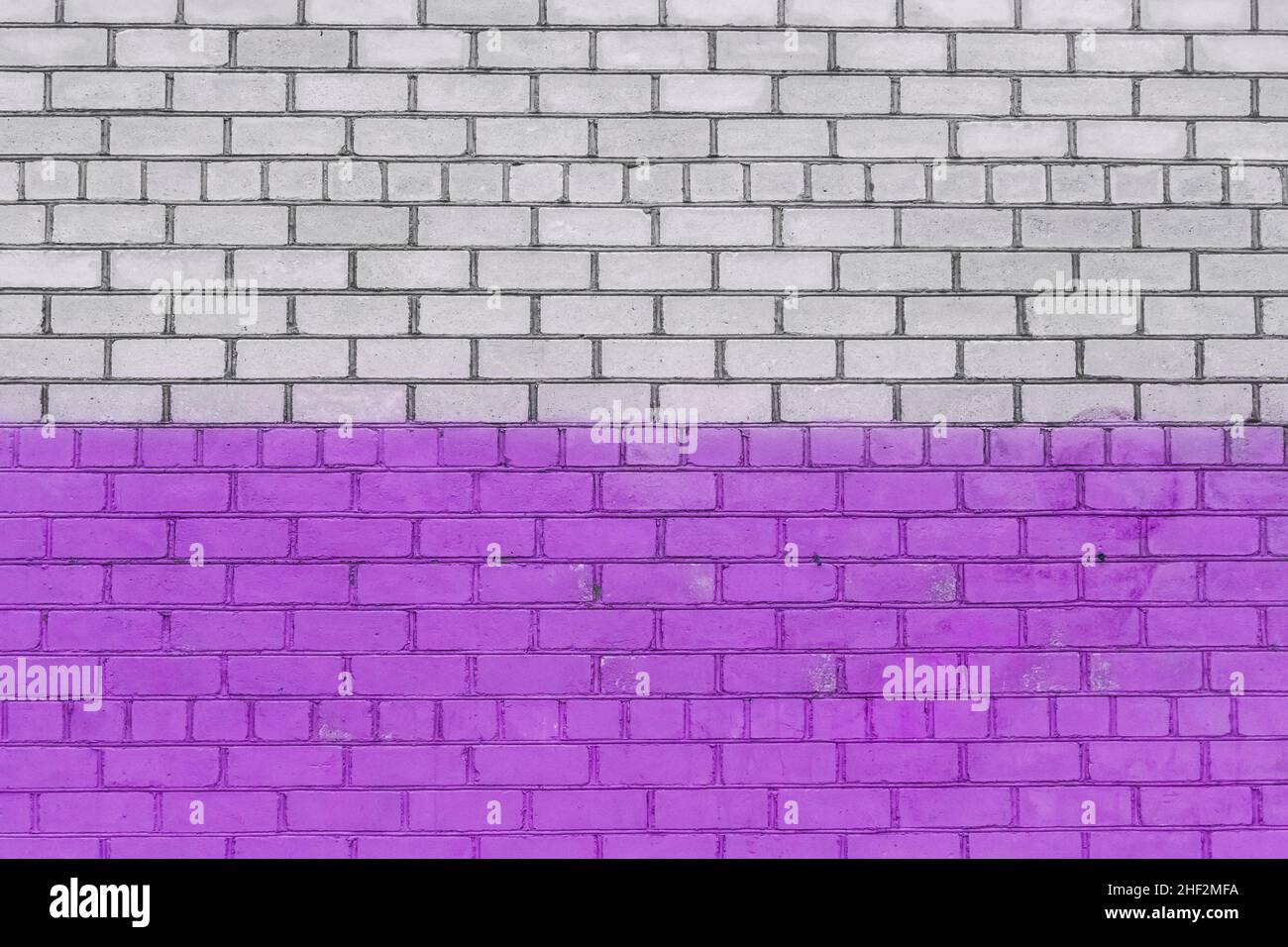 Old white brick wall painted purple paint urban design background texture. Stock Photo