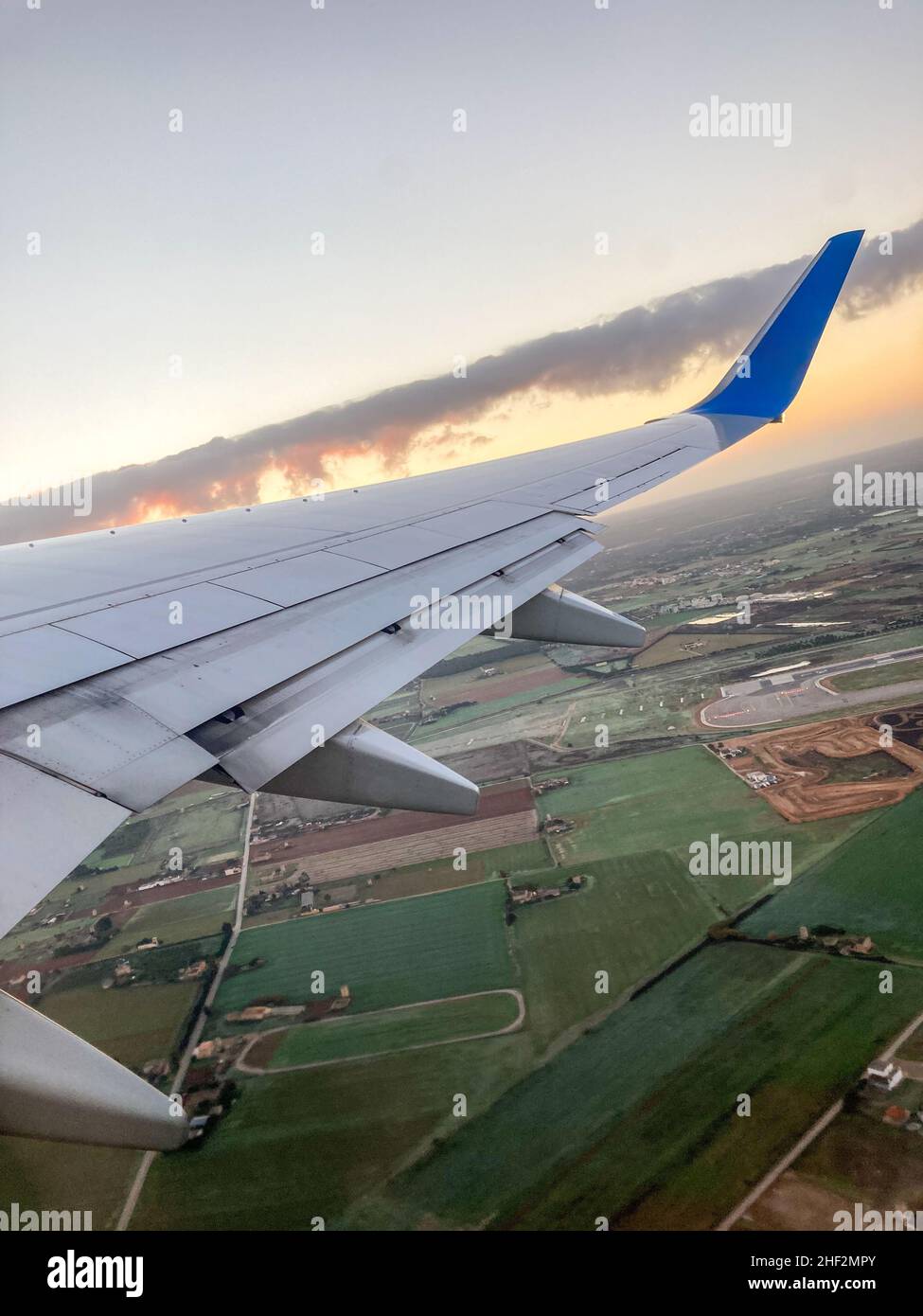Vertical image of the wing of a commercial aircraft. Picture taken from inside the plane. Stock Photo