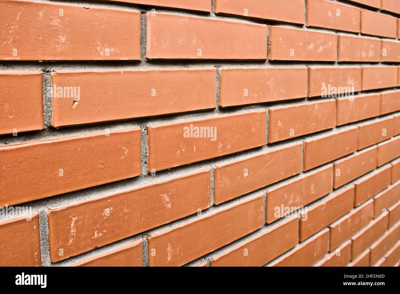 Red brick wall in perspective. Masonry brickwork background. Abstract backdrop. Stock Photo