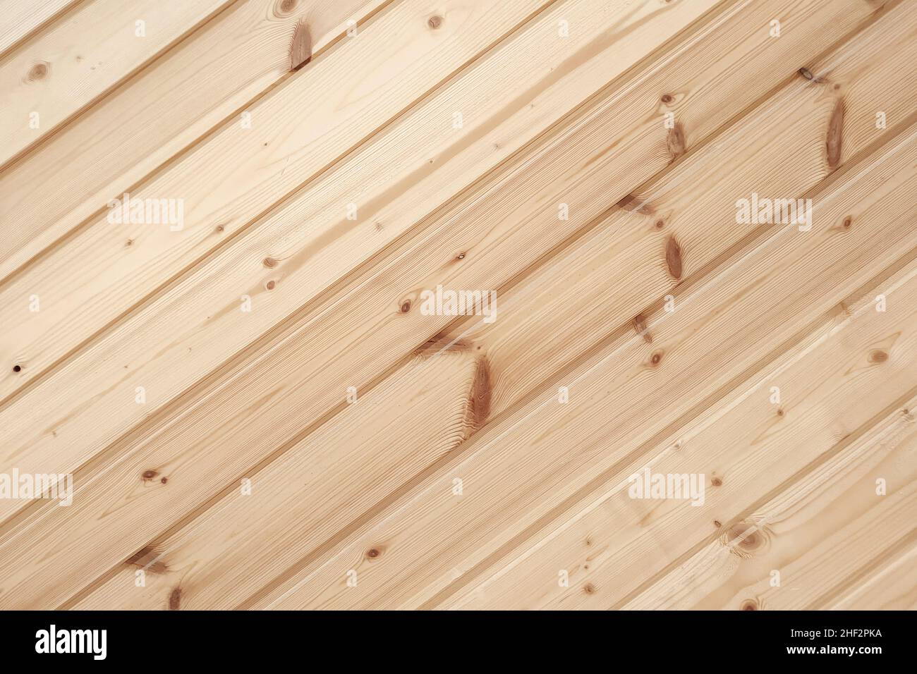 Closeup of clapboard wall. Fragment of diagonal wooden planks