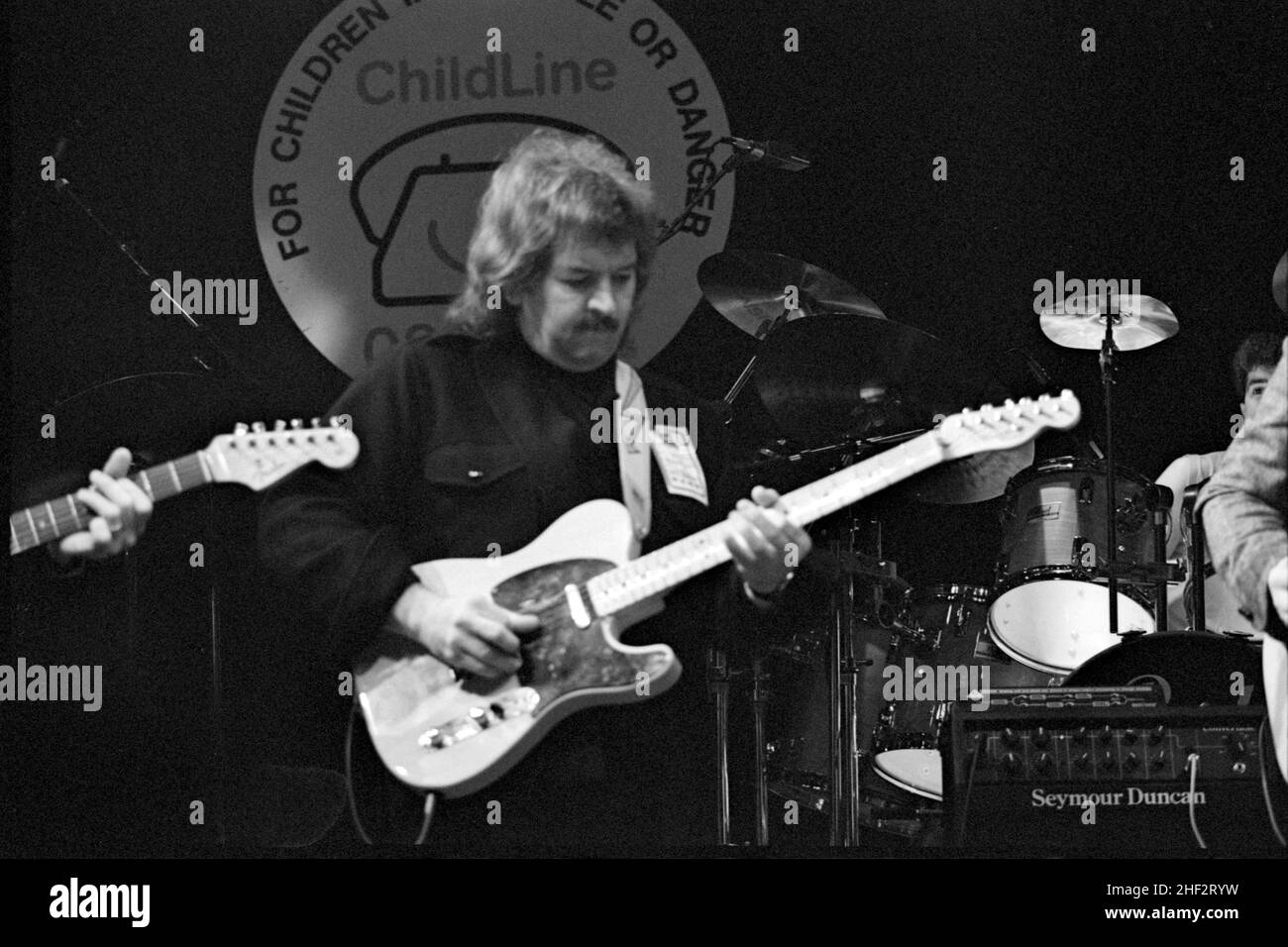 American musician, luthier and businessman Seymour Duncan performing at a charity jam at the Town & Country Club, London, England in 1987. Stock Photo