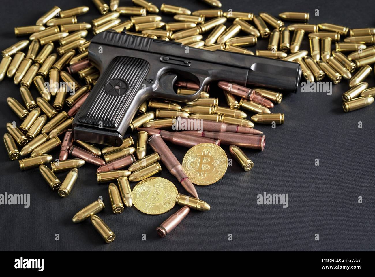 Bronze and brass gun bullets scattered on dark table, black pistol, golden  bitcoin coins near - illegal use of cryptocurrency to purchase weapon conce  Stock Photo - Alamy