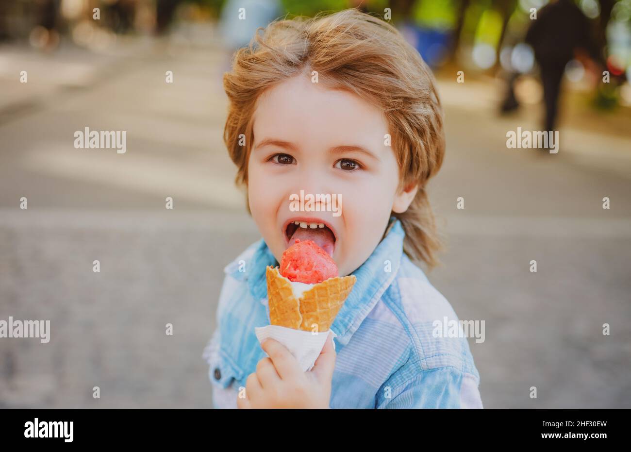 Boy eats ice-cream outdoor. Kids junk food. Delicious summer snacks ...