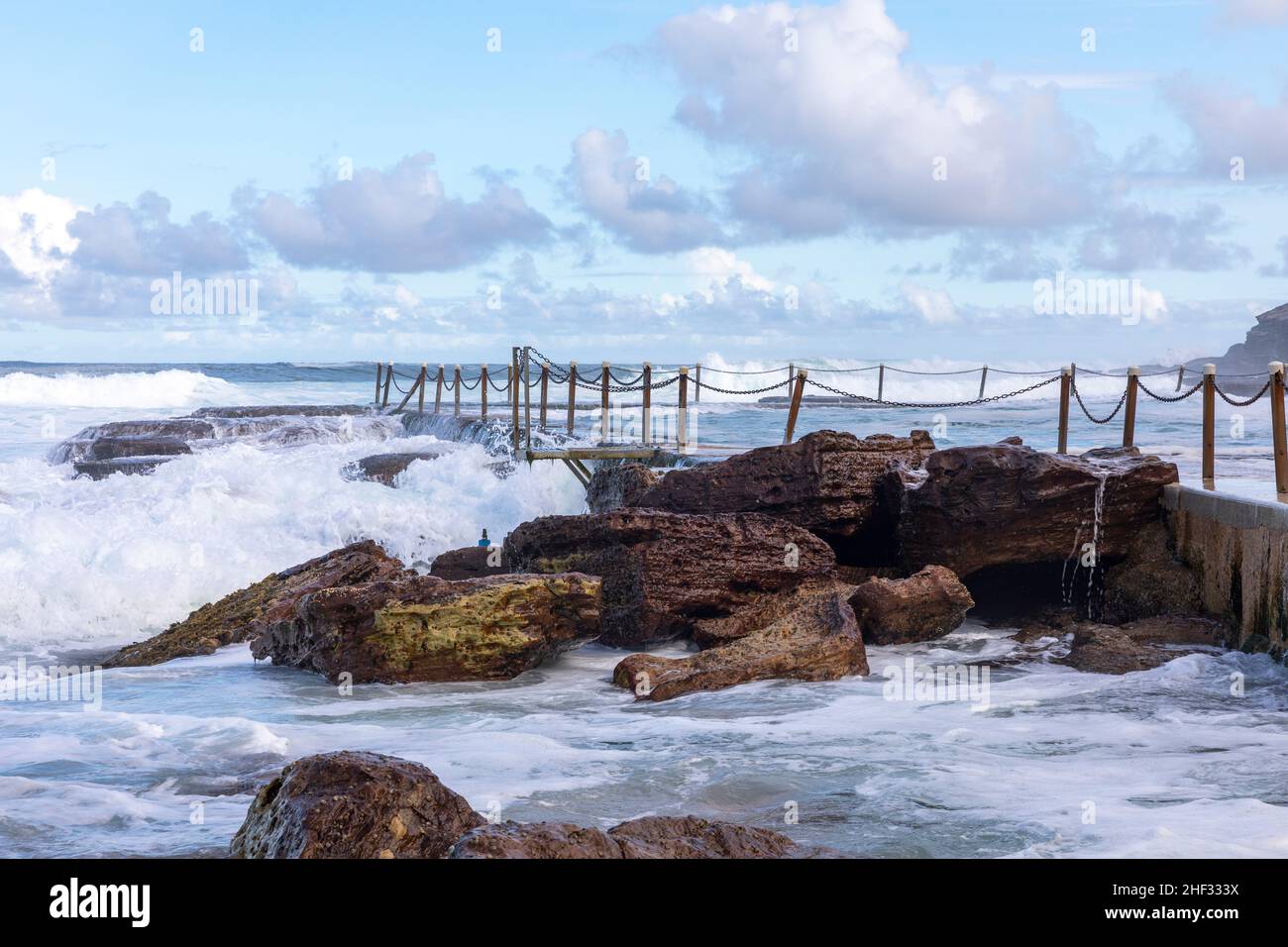 Large waves rolling in over Avalon Beach ocean swimming rock pool late afternoon on summers day,Sydmey,NSW,Australia Stock Photo