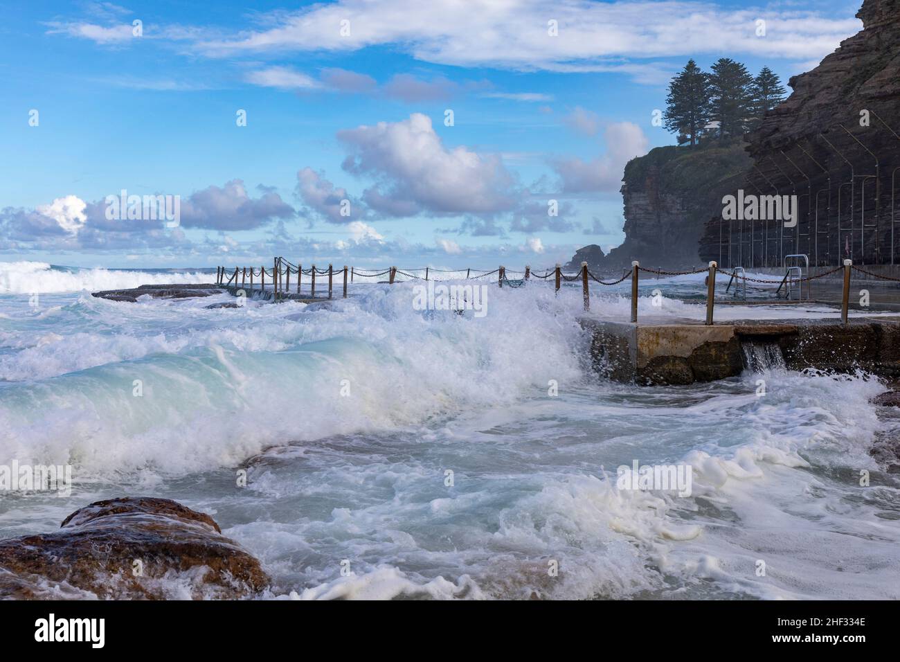 Large waves rolling in onto Avalon Beach Sydney and overpowering the