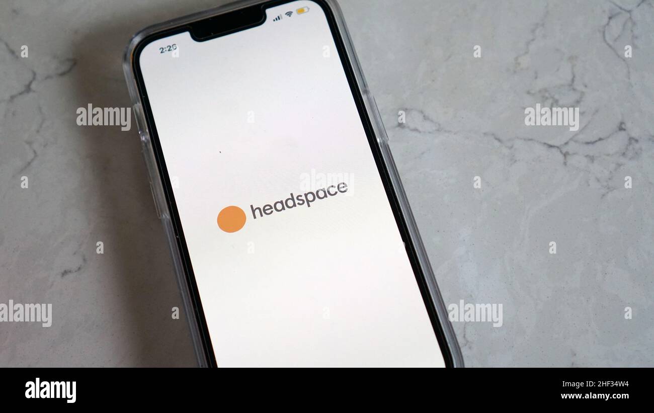 Using Headspace app for mindful breathing and guided meditation Stock