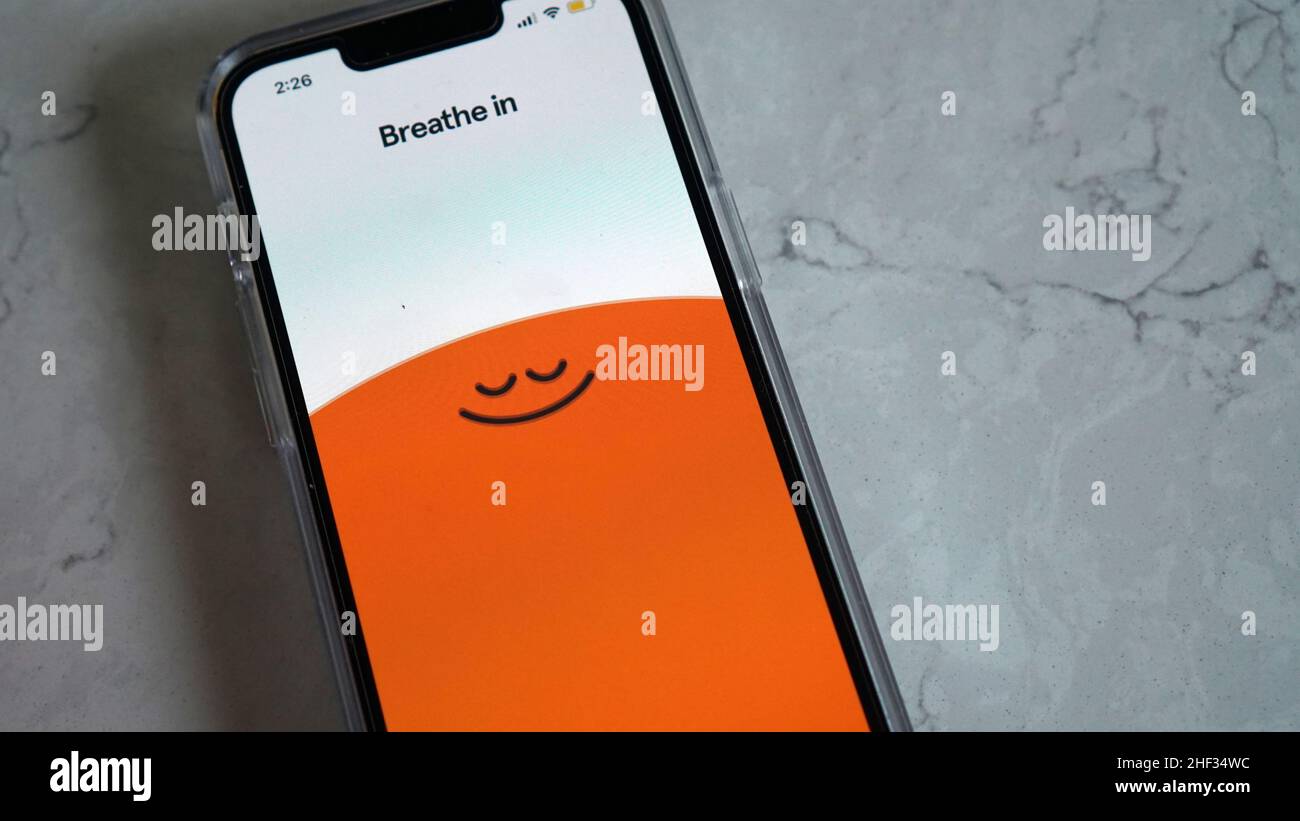 Using Headspace app for mindful breathing and guided meditation Stock