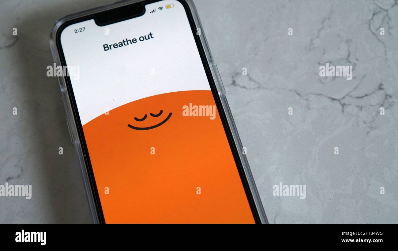 Using Headspace app for mindful breathing and guided meditation Stock