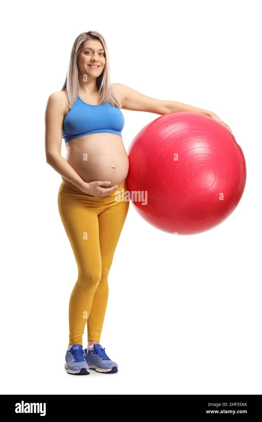 Full length portrait of a pregnant woman in sportswear holding a fitness ball isolated on white background Stock Photo
