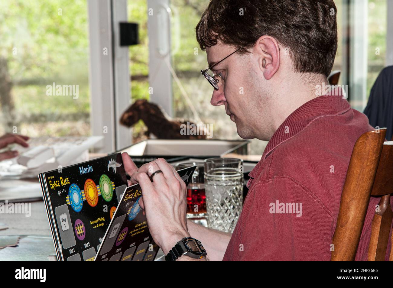 Gamer in the US looks over options for the board game, Space Race Stock Photo