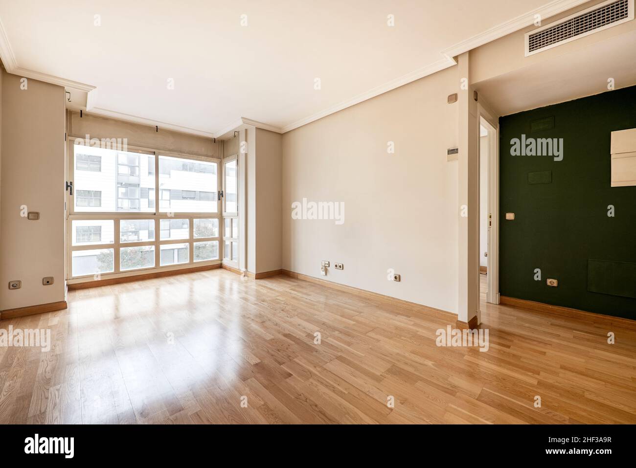 living room with large window, ducted air conditioning and oak parquet