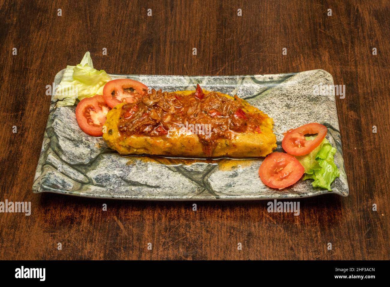 The tamale is a food of pre-Columbian origin, of Mesoamerican cultures, generally prepared based on corn dough or rice stuffed with meats, vegetables, Stock Photo