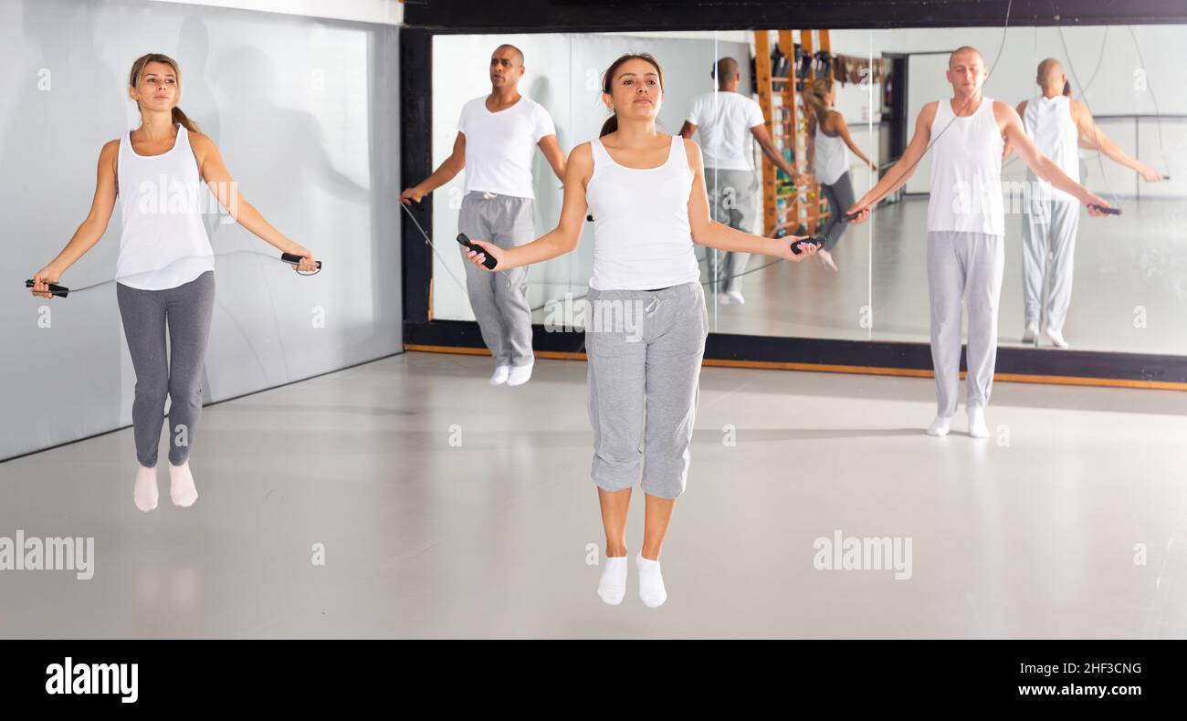 Men and women train in the gym - jump rope Stock Photo - Alamy