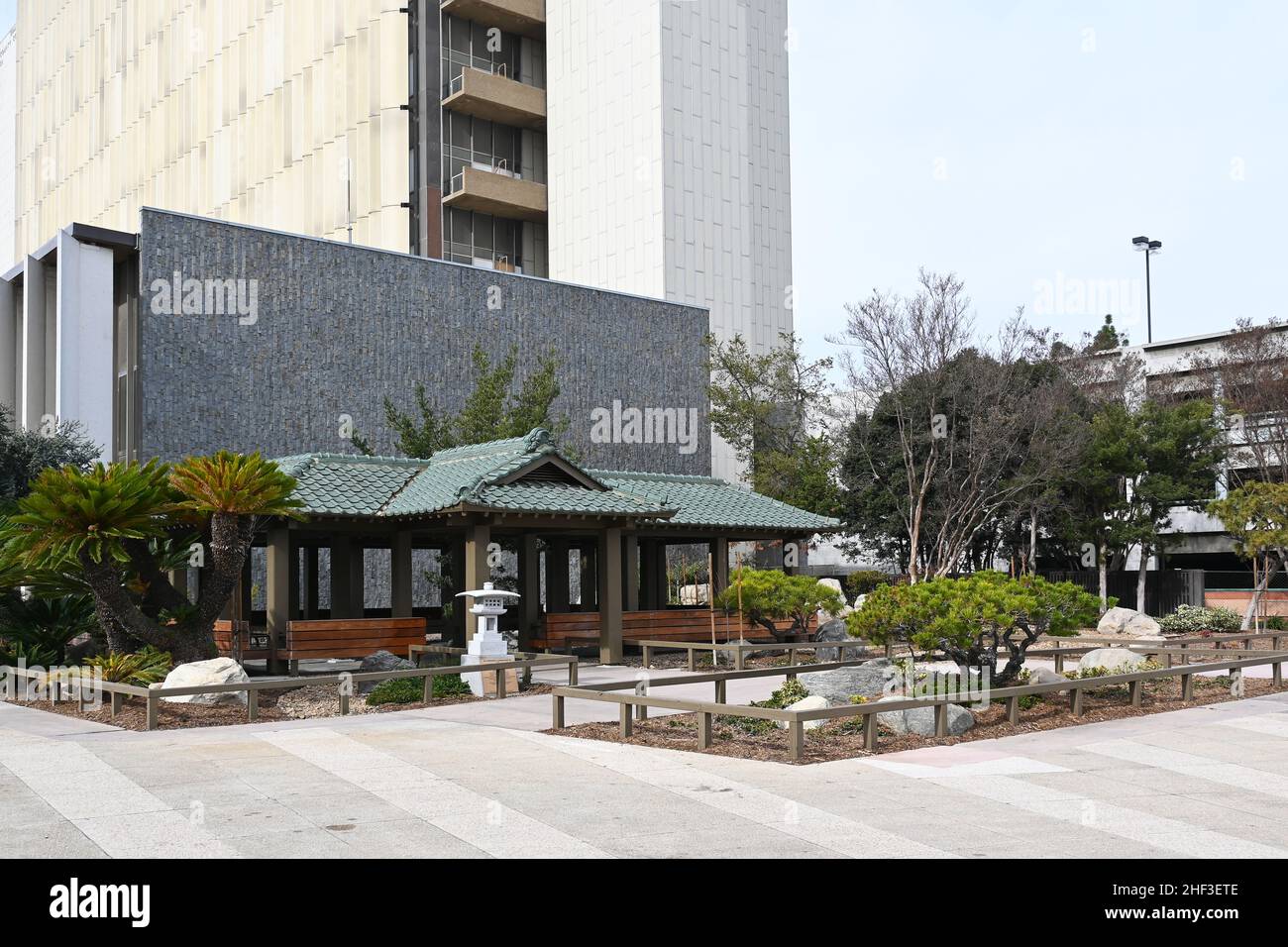 SANTA ANA, CALIFORNIA - 10 JAN 2022:  Japanese Garden and Teahouse, Superior Court Building rising behind in the Orange County Civic Center. Stock Photo