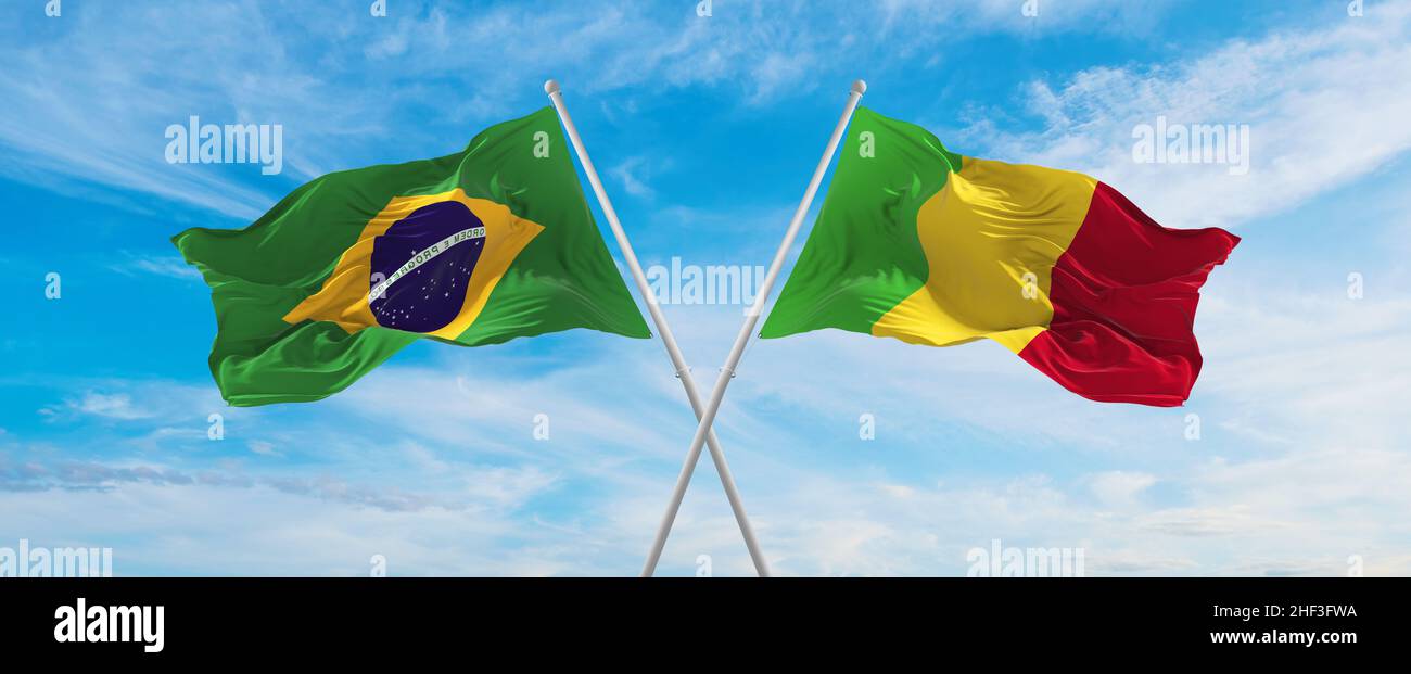 crossed national flags of Brazil and Mali flag waving in the wind at ...