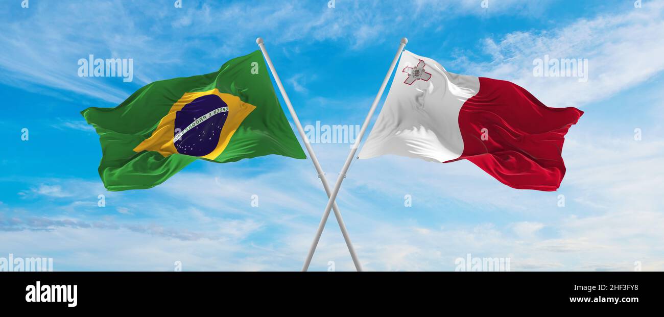 crossed national flags of Brazil and Malta flag waving in the wind at ...