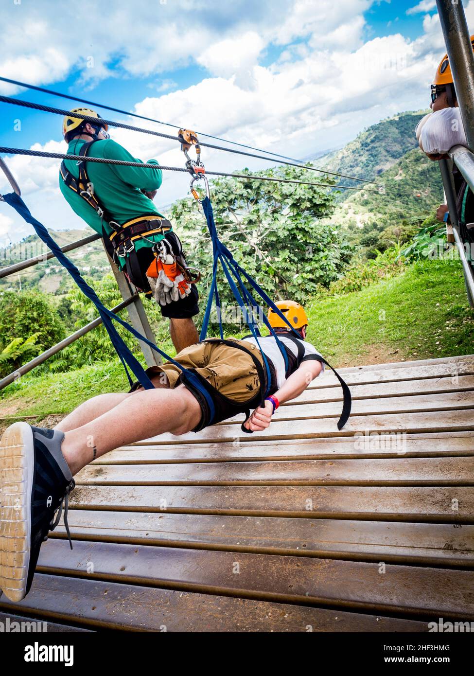 Ziplining in Puerto Rico preparing for flight in prone position Stock